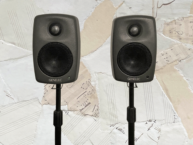 The Genelec 8010A monitors on microphone stands